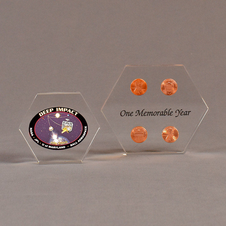 Two hexagon acrylic embedment awards one with cast pennies the other with cast printed Deep Impact design.