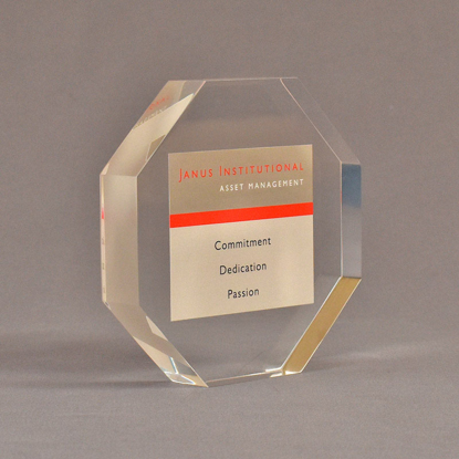 Angle view of 5" x 5" hexagon acrylic embedment award with Janus Institutional Assets tagline cast in clear acrylic.