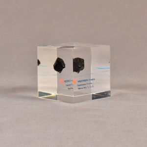 Angle view of 2 1/2" cube acrylic embedment award with small piece of coal cast in clear acrylic.