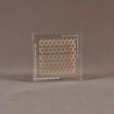 Front view of 4" square acrylic embedment award with metal screen and Cooper Union cast in clear acrylic.