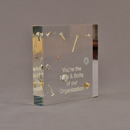 Angle view of 5 1/2" square acrylic embedment award with nuts and bolts cast into crystal clear acrylic.