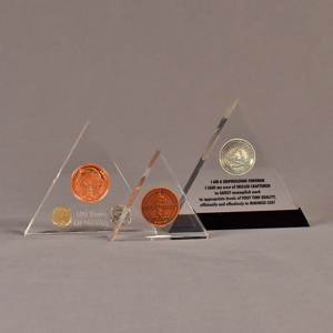 Three triangle acrylic embedment awards showing clarity of cast coins in crystal clear acrylic.