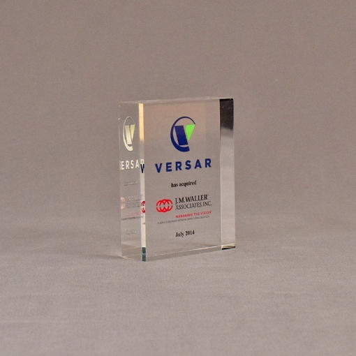 Angle view of 3 1/2" x 3" rectangle acrylic embedment award with VERSAR logo and text cast into acrylic.
