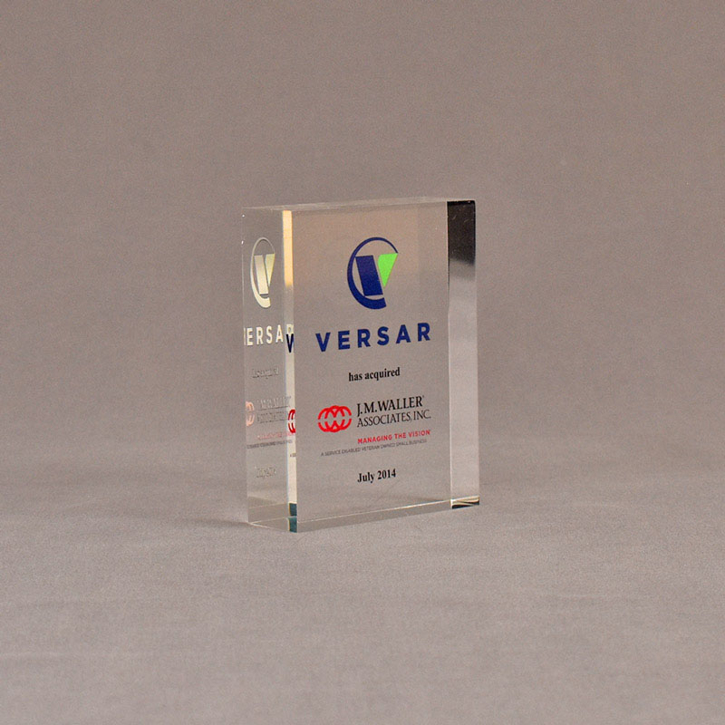Angle view of 3 1/2" x 3" rectangle acrylic embedment award with VERSAR logo and text cast into acrylic.