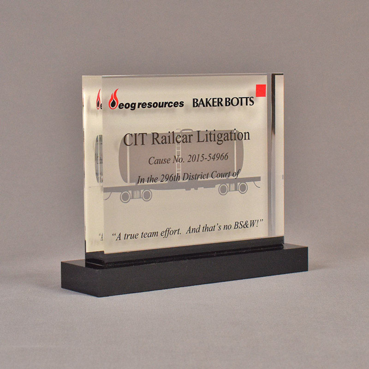 Angle view of 5" x 6" rectangle acrylic embedment award with CIT Railcar Litigation ruling cast into clear acrylic.