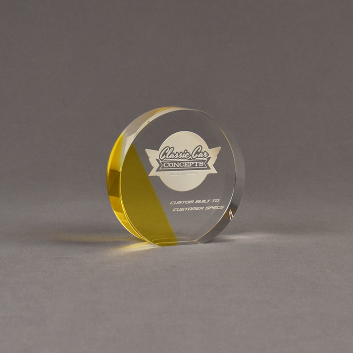 Angle view of ColorCast™ 4" Circle Acrylic Award with yellow transparent color highlight showing trophy laser engraving.