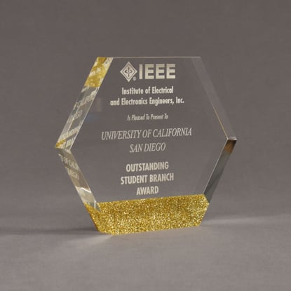 Angle view of ColorCast™ 6" Hexagon Acrylic Award with gold glitter color highlight showing trophy laser engraving.