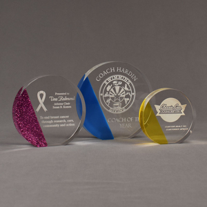 Three ColorCast™ Circle Acrylic Awards grouped showing pink glitter, blue transparent and yellow transparent accent color options.