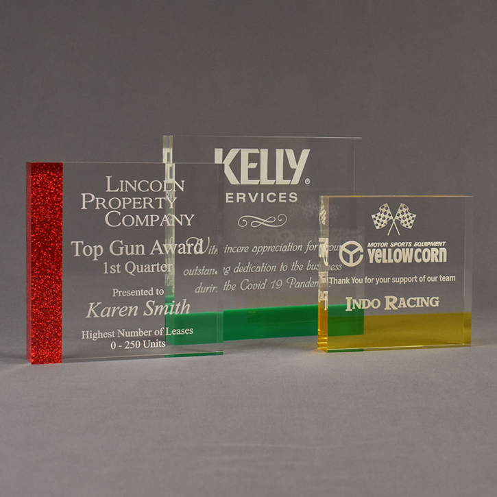 Three ColorCast™ Square Acrylic Awards grouped showing red glitter, green and transparent yellow accent color options.