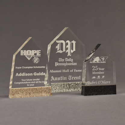 Three Composites™ Obelisk Acrylic Awards grouped showing Staron® Aspen Brown, Platinum Grey and Sanded Black Onyx accent options.