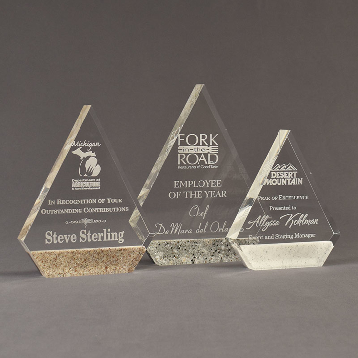Three Composites™ Peak Acrylic Awards grouped showing Staron® Aspen Brown, Platinum Grey and Sanded White Pepper accent options.