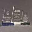 Three ColorCast™ Apex Acrylic Awards grouped showing blue glitter, white and black gliter accent color options.