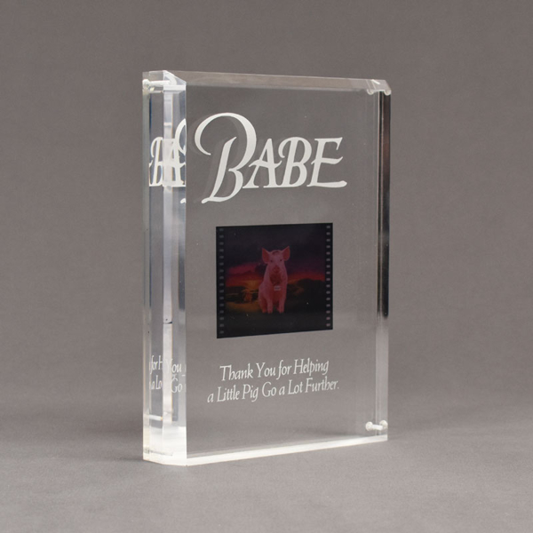 Angle view of Allure™ 7" x 9" Acrylic Entrapment Award with studio film clip of Babe movie sandwiched inside two pieces of crystal clear acrylic.