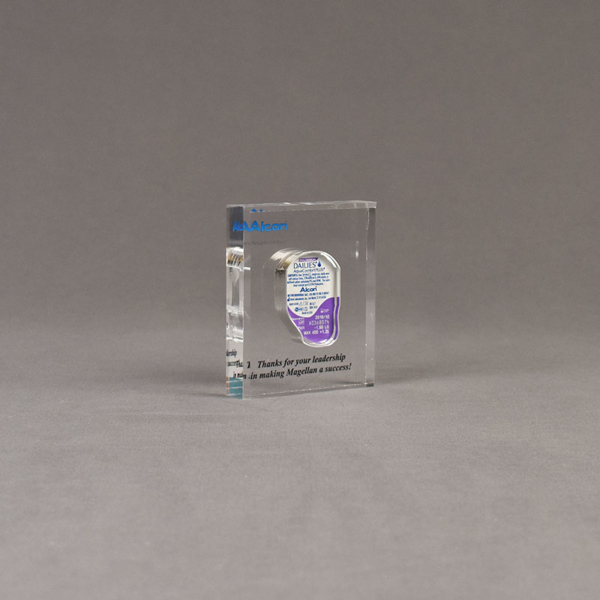 Angle view of x-small Allure™ Floating Acrylic Encasement Award with Alcon medical device sample encased into clear acrylic showing full color imprint.