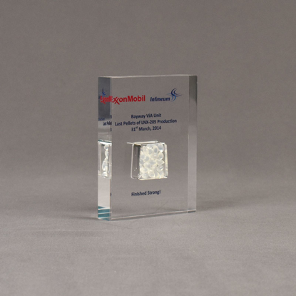 Angle view of small Allure™ Floating Acrylic Encasement Award with Exxon Infineum pellet sample encased into clear acrylic showing full color imprint.