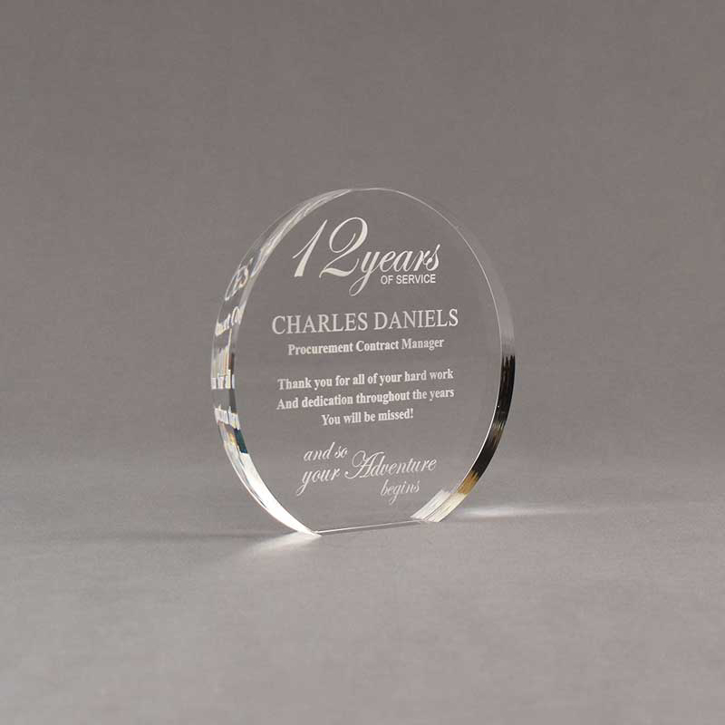 Angle view of Aspect™ 5" Round™ Acrylic Award featuring laser engraved 12 Years of Service logo and retirement text.