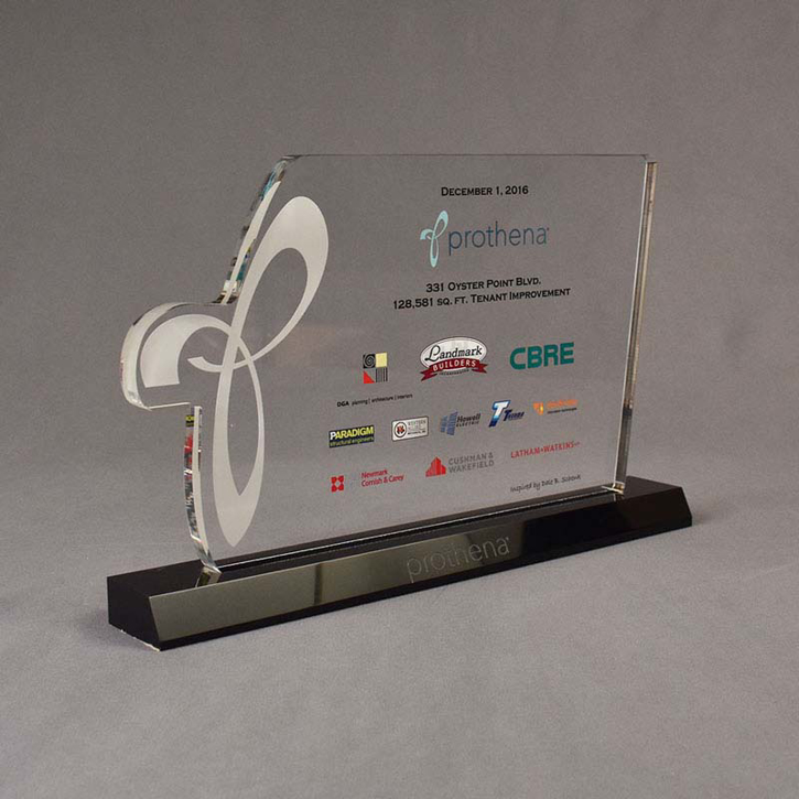 Angle view of 80 Square Inch Premiere Series LaserCut™ Acrylic Award with custom shape of Prothena P logo and local tenant logos.
