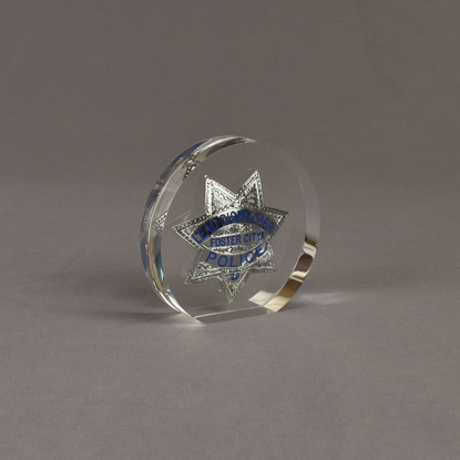 Angle view of Circle Lucite® Badge Embedment with star shaped police service badge cast inside clear acrylic.