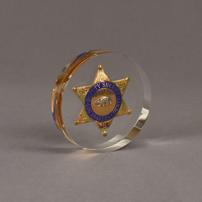 Angle view of 5" Circle Lucite® Badge Embedment with star shaped sheriffs service badge cast inside clear acrylic.
