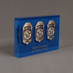 Side view of Lucite® Badge Embedment with two police and one marine supervisor service badges cast inside clear acrylic.