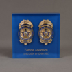 Front view of Lucite® Badge Embedment with police and detective service badges cast inside clear acrylic.