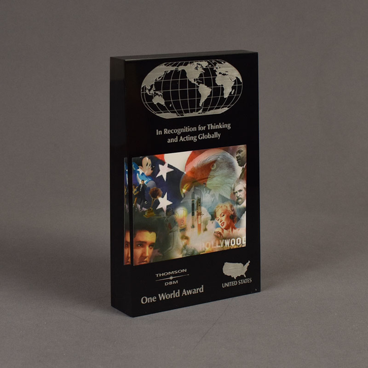 The angle view of the Thomson/DBM Deal Toy features a full color printed paper insert gracefully embedded inside Lucite® with a black acrylic accent background.